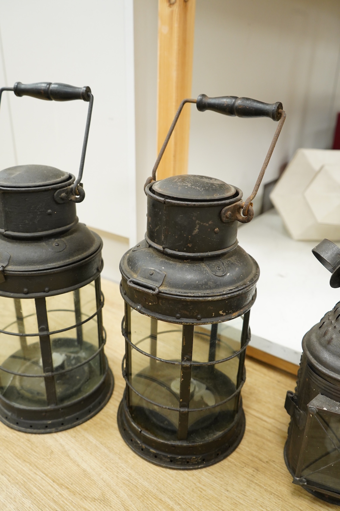 A pair of early 20th century railway hanging lanterns and one other, largest each 45cm high including swing handle